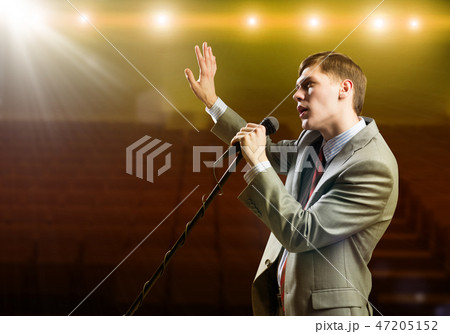 Businessman with microphone 47205152