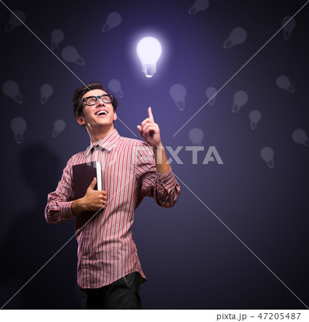 young man holding a book young man holding a book 47205487