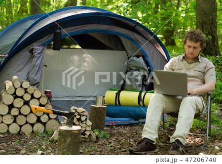 Man Working Outdoors In A Tent Camp. Man Working Outdoors In A Tent Camp. 47206740