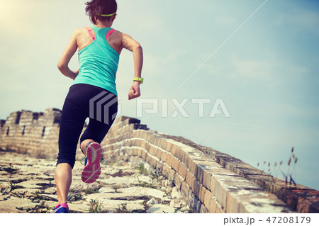 woman cross country running on chinese great wall. woman cross country running on chinese great wall. 47208179