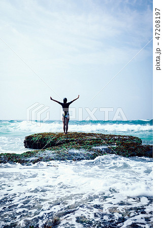woman outstretched arms at seaside  coral reef 47208197