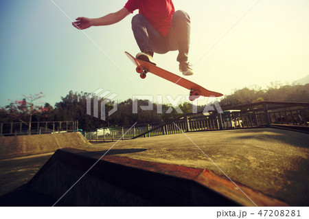Skateboarder skateboarding at skatepark ramp Skateboarder skateboarding at skatepark ramp 47208281