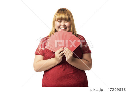 Asian woman holding red packet monetary gift. 47209858