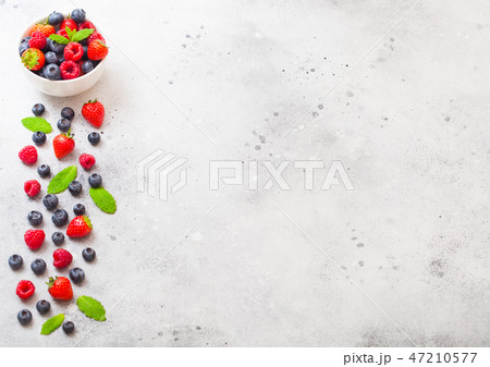 Fresh raw organic berries in white ceramic bowl  47210577