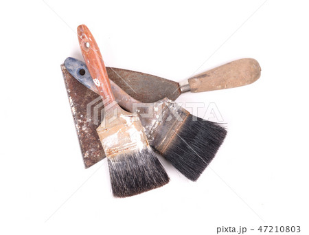 Old paintbrushes with a putty knife 47210803