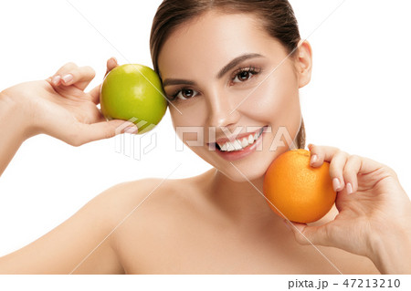 portrait of attractive caucasian smiling woman isolated on white studio shot eating green apple 47213210