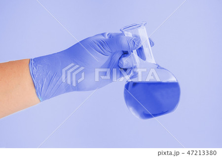 Laboratory glassware or test tube in hand 47213380
