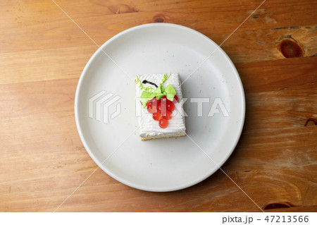 Strawberry cake on white dish, isolated. 47213566