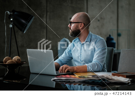 Middle-aged designer working in office Middle-aged designer working in office 47214143