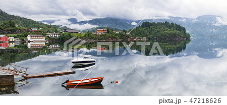 Two lonely boats on calm water of fjord, Norway 47218626