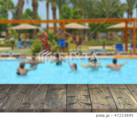 Vintage wooden boards with dancing women in pool 47223695