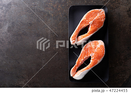Fresh salmon fish steaks on black background 47224455