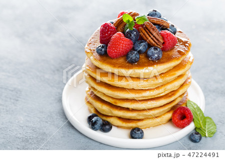 Stack of fluffy pancakes with fresh berries 47224491