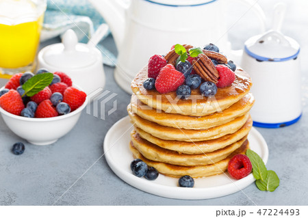 Stack of fluffy pancakes with fresh berries 47224493