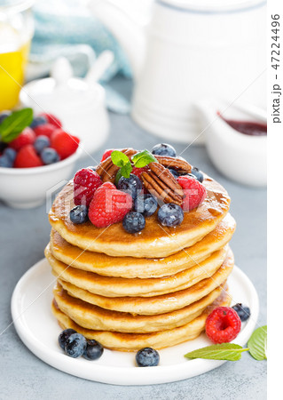 Stack of fluffy pancakes with fresh berries Stack of fluffy pancakes with fresh berries 47224496