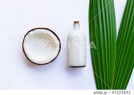 Coconut with coconut milk on white Coconut with coconut milk on white 47225832