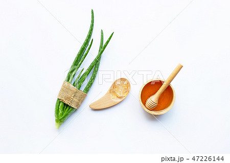 Wooden bowl of honey and aloe vera. Wooden bowl of honey and aloe vera. 47226144