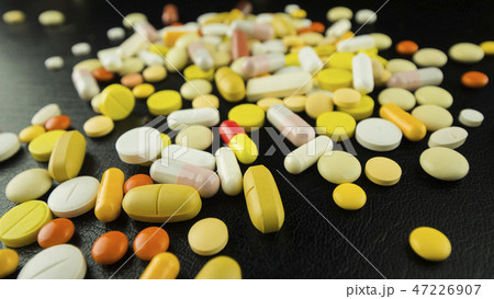 Drugs scattered on a black table Drugs scattered on a black table 47226907