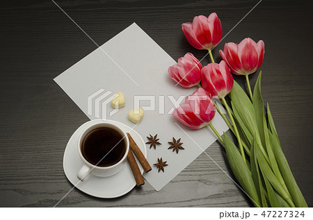 Holiday concept. Bouquet of pink tulips, a cup 47227324