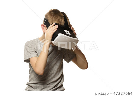 Boy experiencing virtual reality head bowed 47227664