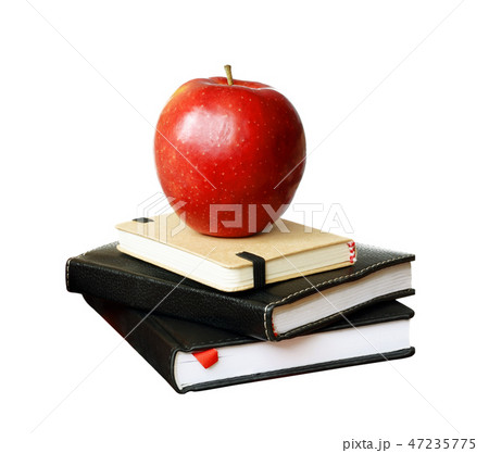 Notebooks and an apple Notebooks and an apple 47235775