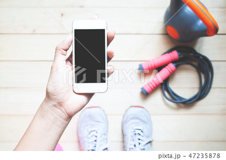 Top view sporty woman holding smart phone. 47235878