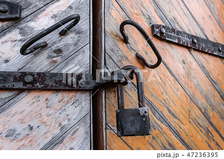 Padlock on the old gate 47236395