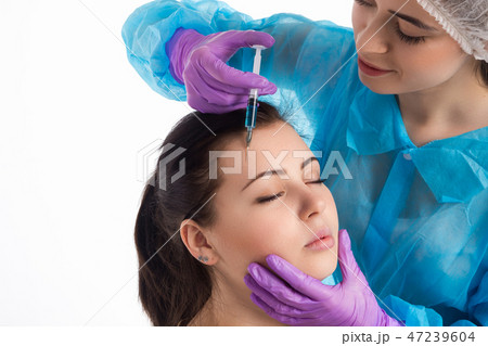 Doctor injects a botox Doctor injects a botox 47239604