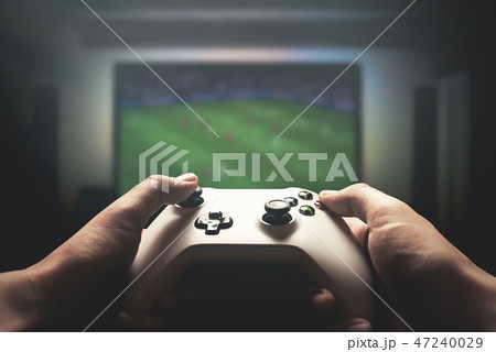 Video gaming console. Man playing soccer game 47240029