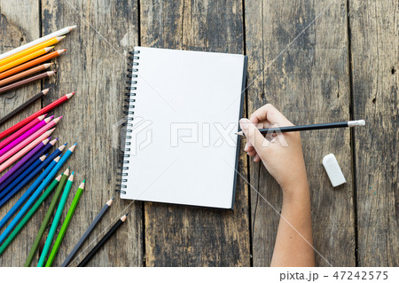 Girl hand drawing, blank paper and colorful pencil Girl hand drawing, blank paper and colorful pencil 47242575