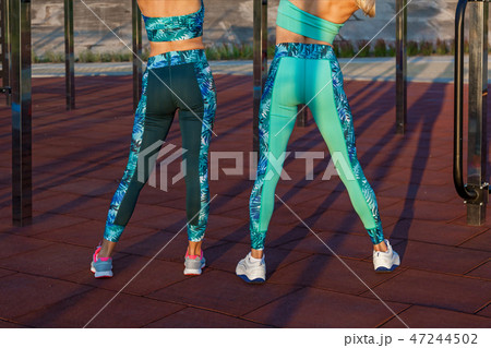 girls doing exercises on the sports field 47244502