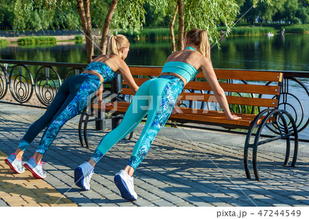 girls doing exercises on the sports field girls doing exercises on the sports field 47244549