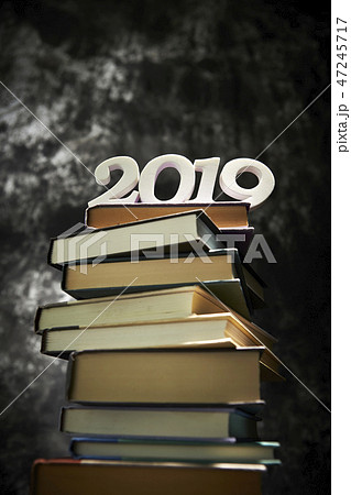 積み上げられた本の上の2019の数字 47245717