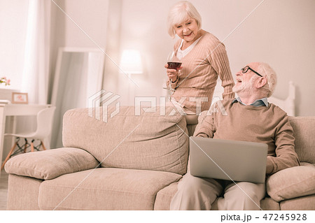 Relaxed mature female person enjoying red wine Relaxed mature female person enjoying red wine 47245928
