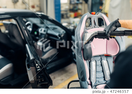 Carwash, removing of dust and dirt from child seat Carwash, removing of dust and dirt from child seat 47246357
