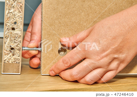 Handyman connects two parts of table Handyman connects two parts of table 47246410