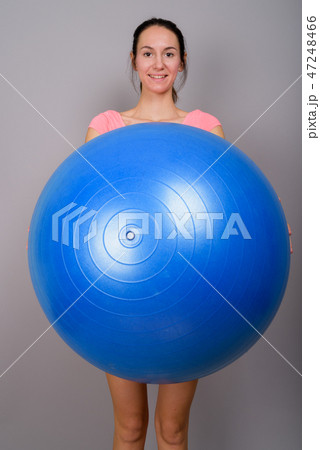 Young beautiful woman ready for gym holding exercise ball Young beautiful woman ready for gym holding exercise ball 47248466