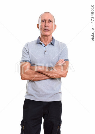 Studio shot of senior man standing with arms crossed Studio shot of senior man standing with arms crossed 47249010