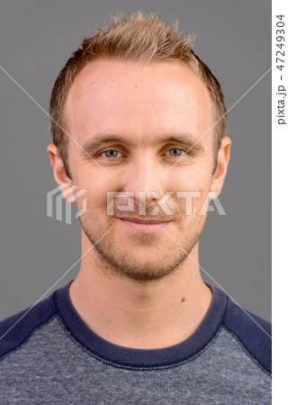Face of handsome Caucasian man studio portrait against gray background Face of handsome Caucasian man studio portrait against gray background 47249304