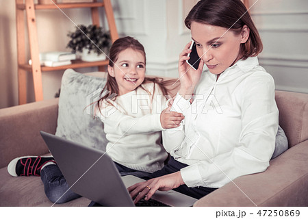 Nice young woman discussing her work on the phone 47250869