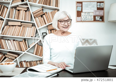 Cheerful senior woman working with great pleasure 47251801