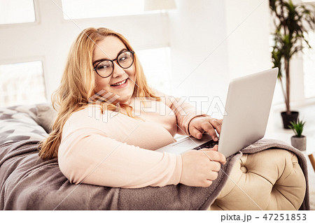 Smiling long-haired lady spending time in her fashionable apartments 47251853