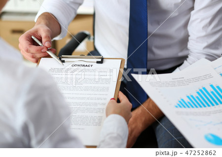 Male arm offer contract form on clipboard pad Male arm offer contract form on clipboard pad 47252862