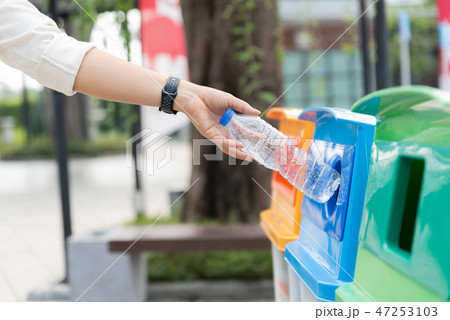 Closeup portrait woman hand throwing empty bottle Closeup portrait woman hand throwing empty bottle 47253103