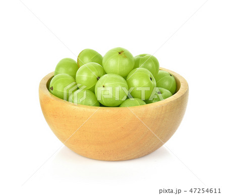 Indian gooseberry in wooden bowl white background Indian gooseberry in wooden bowl white background 47254611