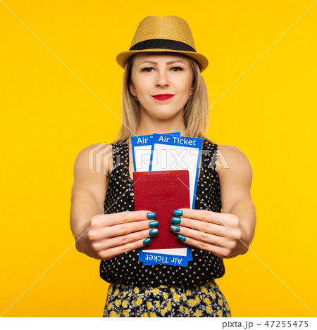 Young smiling student holding boarding pass ticket Young smiling student holding boarding pass ticket 47255475
