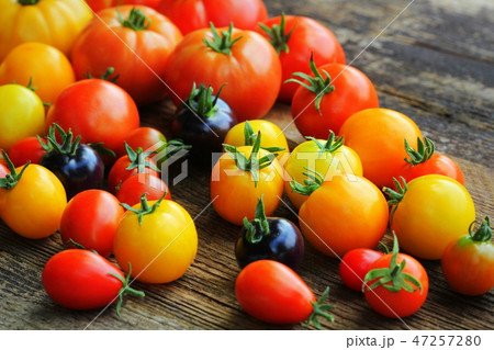 Heirloom variety tomatoes on rustic table. Colorful tomato - red,yellow , black, orange. Harvest 47257280