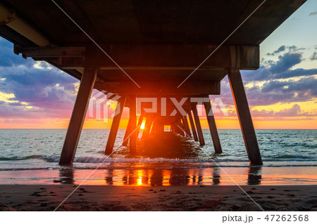 Sunset view through Glenelg jetty pylons 47262568