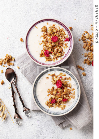 Granola with yogurt and dried raspberries Granola with yogurt and dried raspberries 47263620