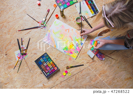 Young artist sitting on the floor. Young artist sitting on the floor. 47268522